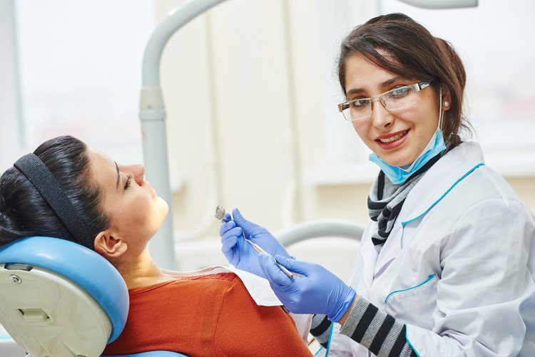 female asian dentist doctor at work